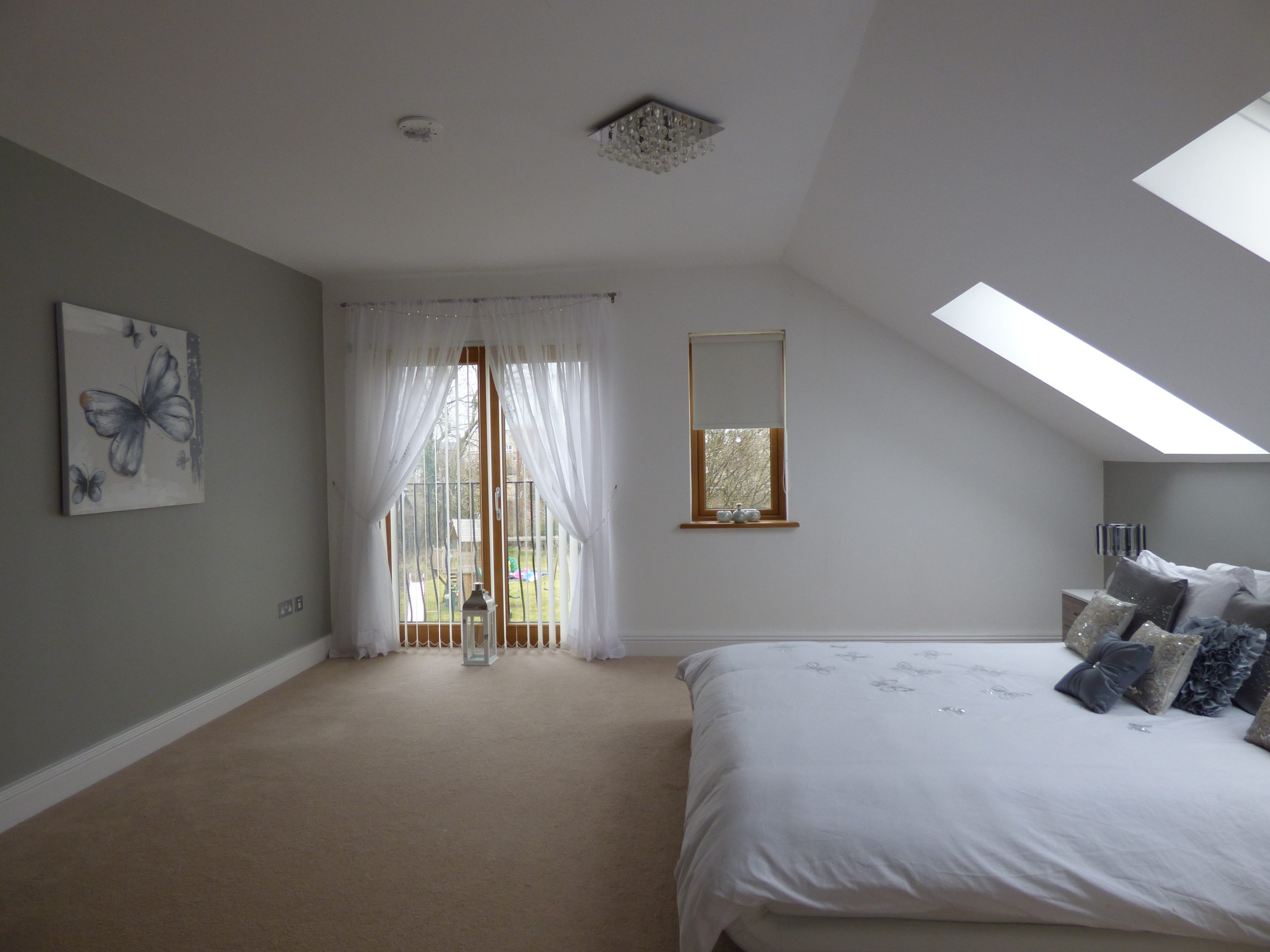 Bedroom with light grey walls and white trim