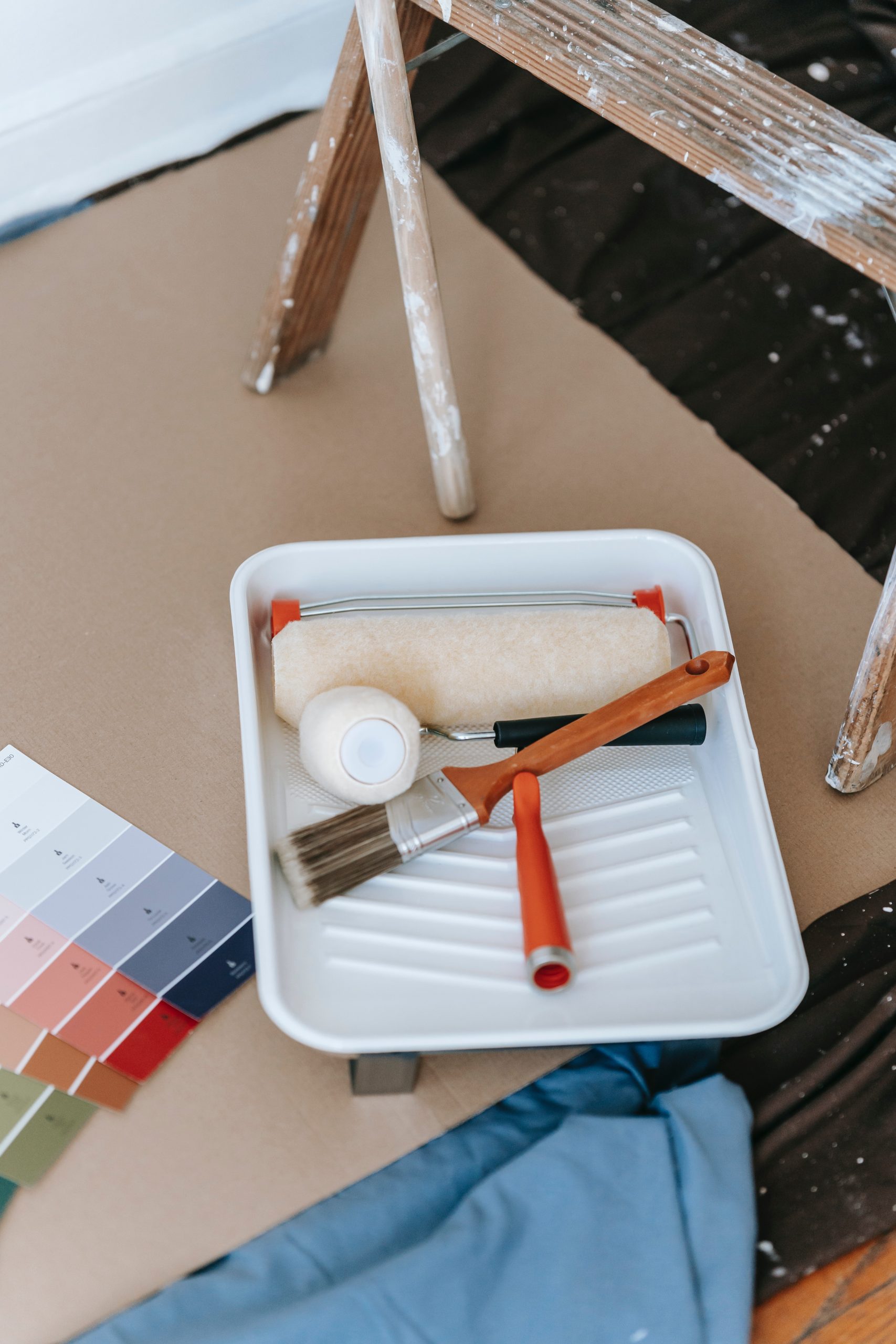 Tools for painting, color swatches, paint roller, paint brush, ladder, etc.